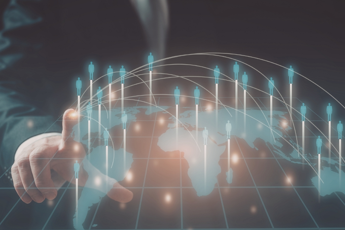 Headless man pointing at a digital 3D visualization of figures on global map